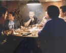 Men sitting around a dimly lit table.