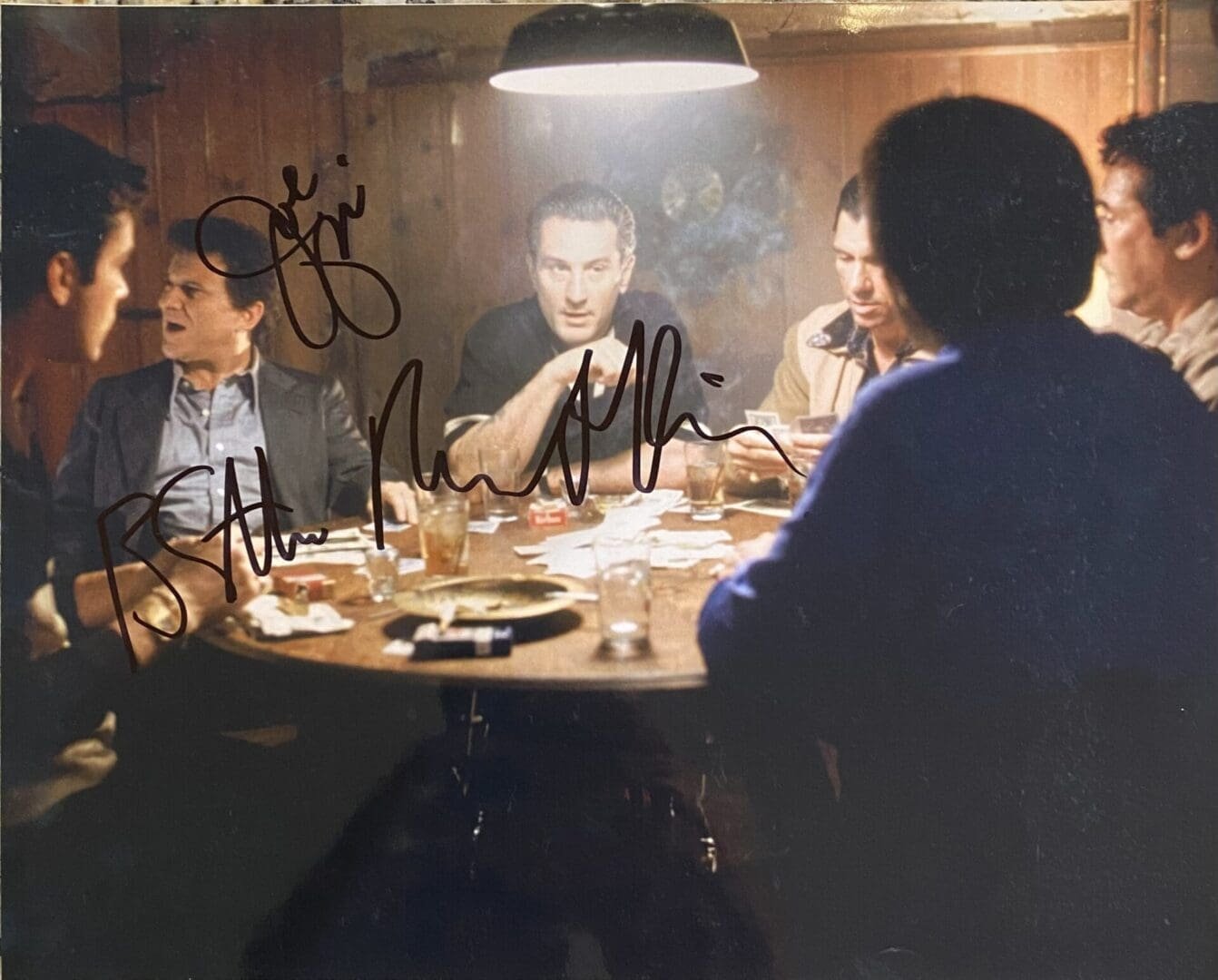 Men sitting around a dimly lit table.