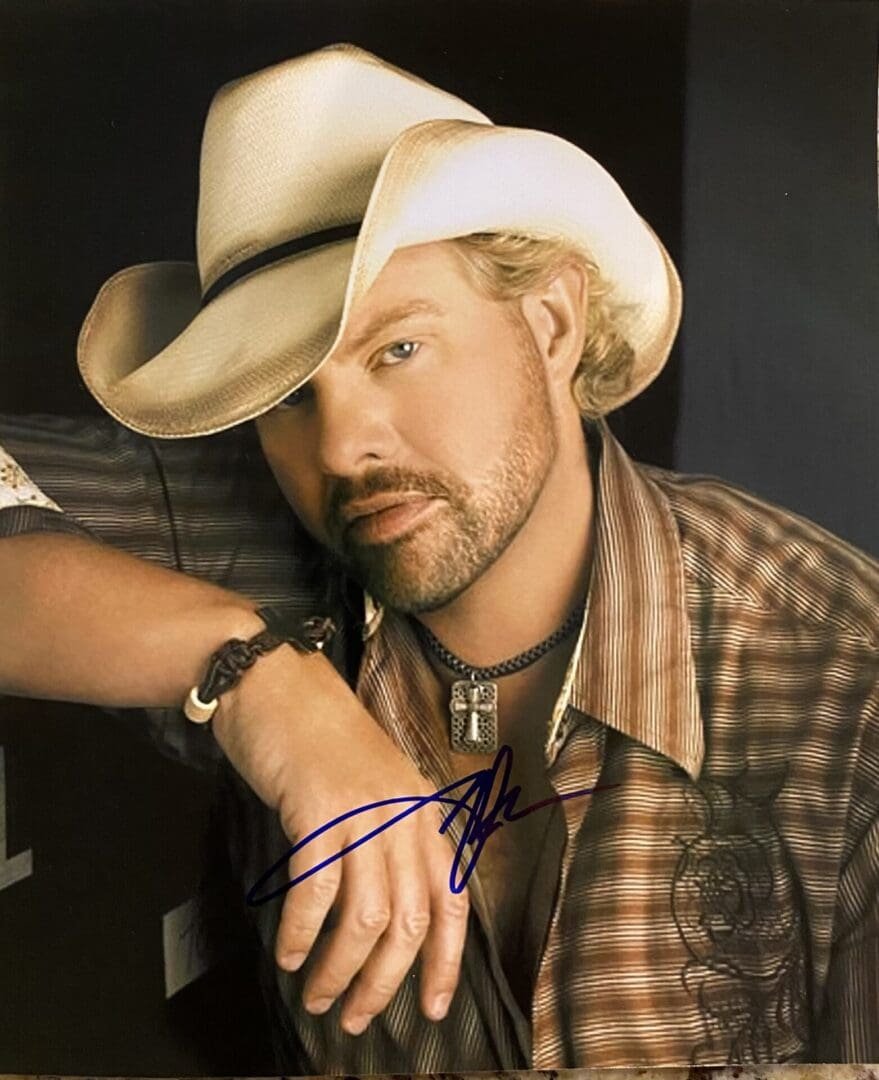 Man in cowboy hat and plaid shirt.
