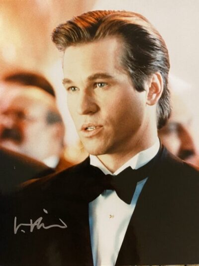 Man in tuxedo with slicked-back hair.
