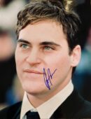 Smiling man in suit with autograph.