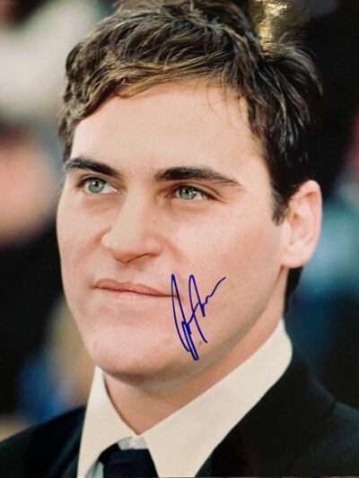 Smiling man in suit with autograph.