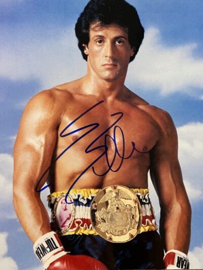 Boxer with championship belt and gloves.