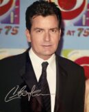 Man in suit with autograph on photo.