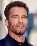 Man in suit with autograph on photo.