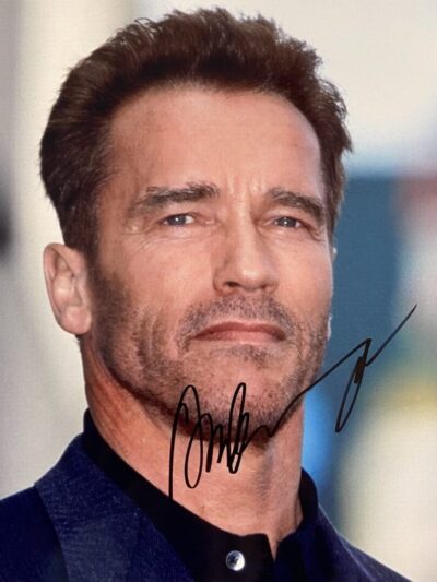 Man in suit with autograph on photo.
