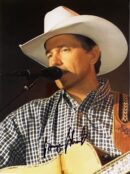 Singer performing in cowboy hat with guitar.