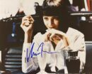 Woman in diner with milkshake and cigarette.