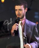 Man holding microphone and award