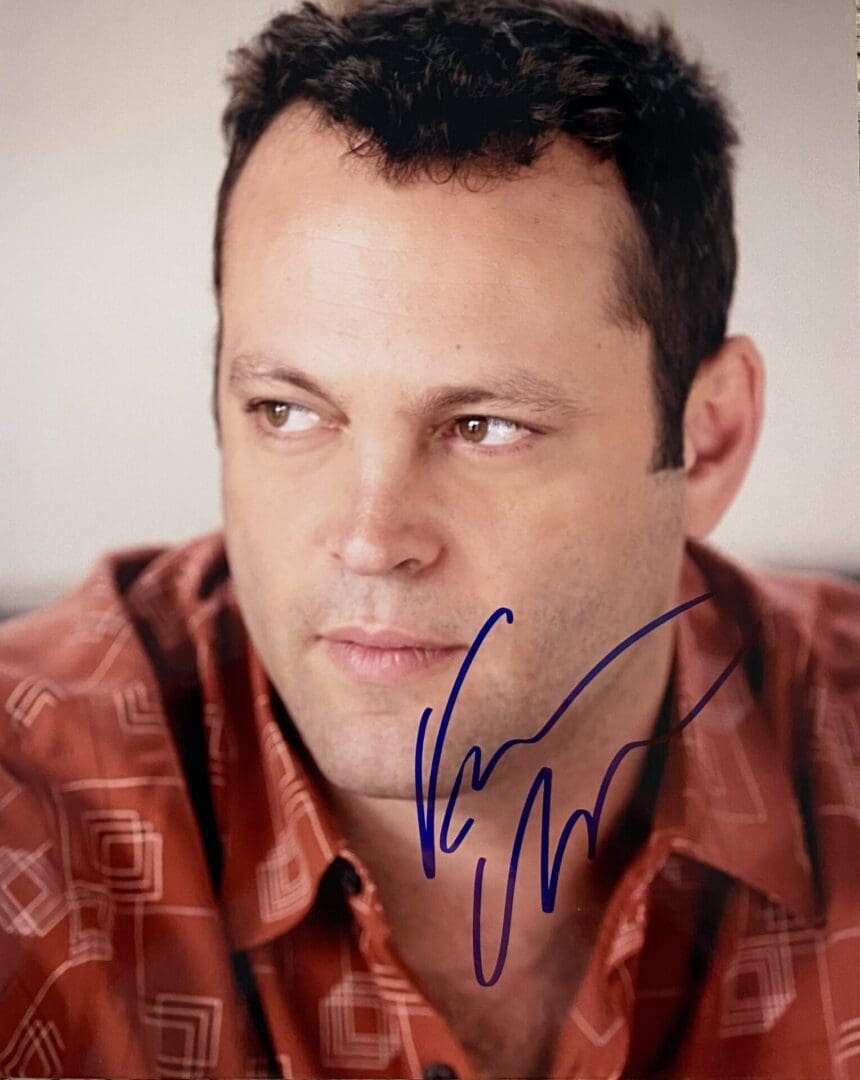 Man in patterned shirt with autograph.