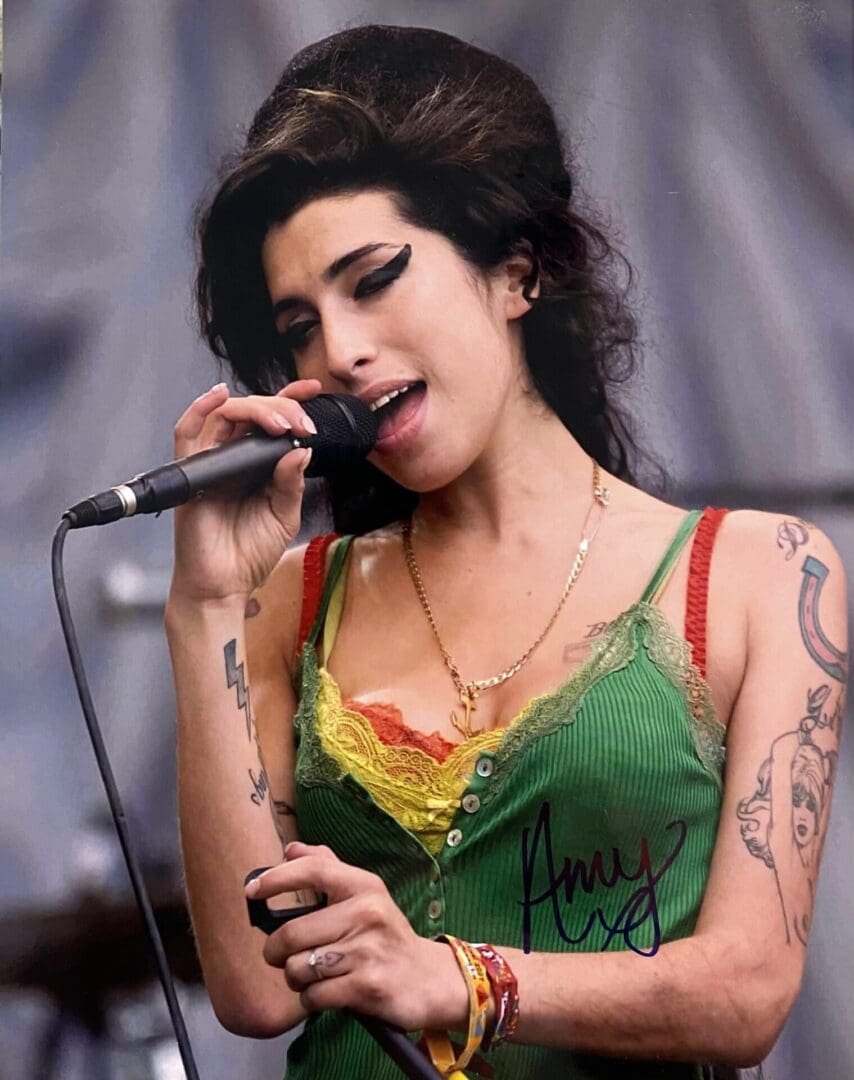 Singer performing with microphone on stage.