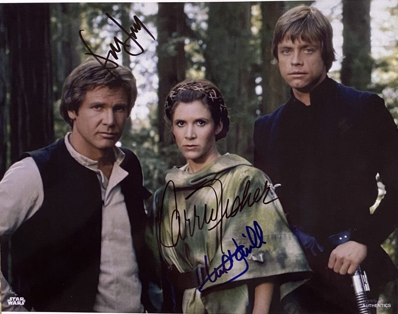 Three characters in forest with autographs.