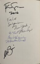Handwritten signatures and messages on a page.
