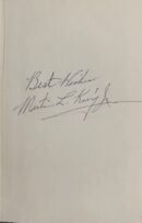 Handwritten note with a signature.