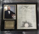Framed portrait and document of historical figure.