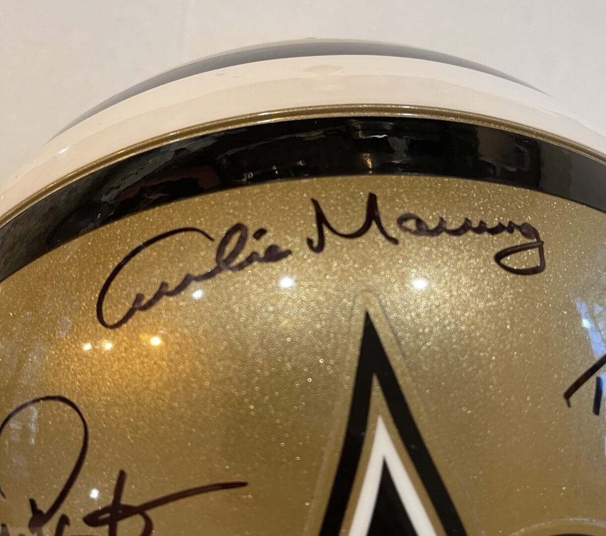 Autographed gold helmet with star design.