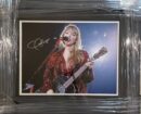 Framed photo of singer with guitar.