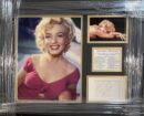 Framed Marilyn Monroe photos and signature display.