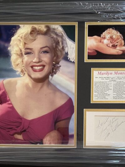 Framed Marilyn Monroe photos and signature display.