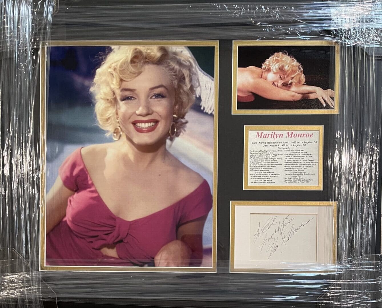 Framed Marilyn Monroe photos and signature display.