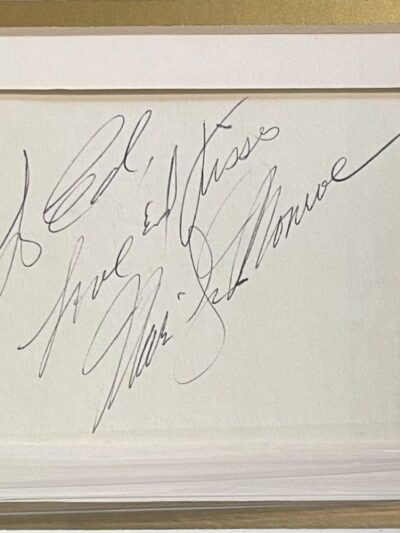 Framed handwritten note with elegant script.