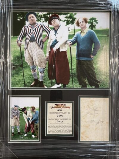 Framed photo and signatures of three golfers.