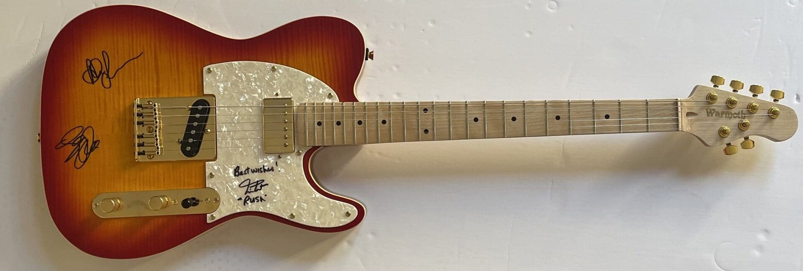 Electric guitar with autographs on white background.