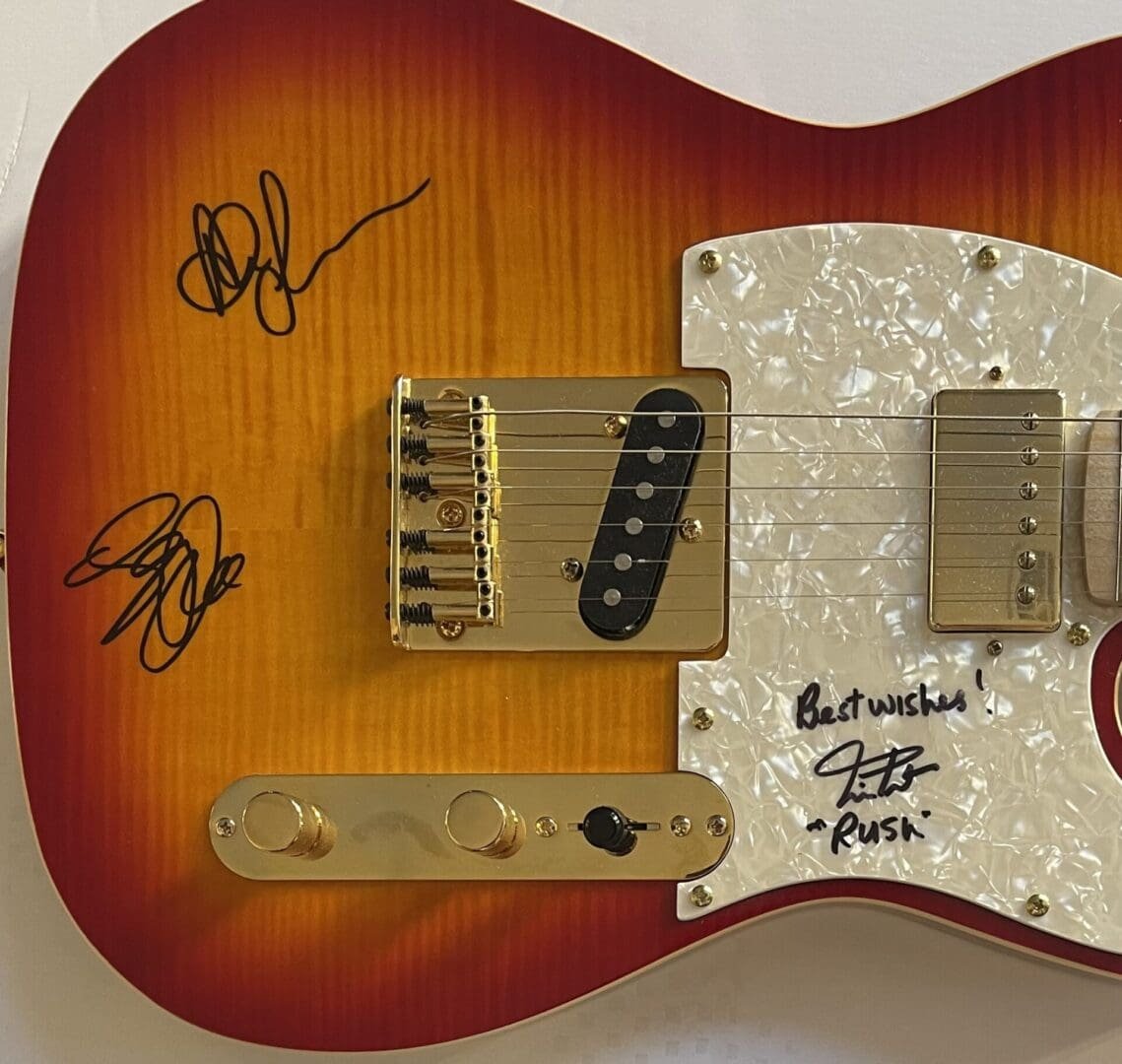 Autographed electric guitar with sunburst finish.
