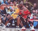 Two basketball players in action on court.