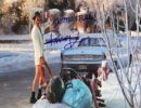 Man in robe standing outside in snow.
