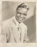 Smiling man in suit with autograph.