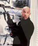 Man holding a gun in armory room.