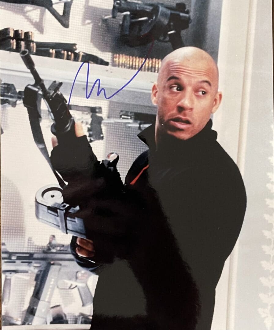 Man holding a gun in armory room.