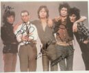 Five people posing with autographs on photo.