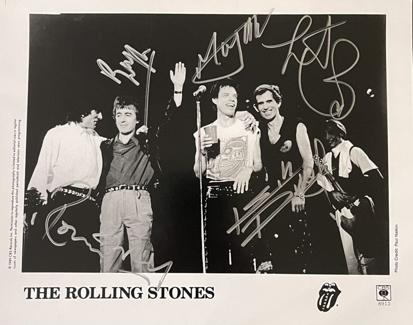 Black-and-white band photo with signatures.