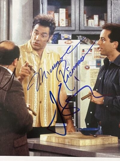 Three men talking in a kitchen scene.