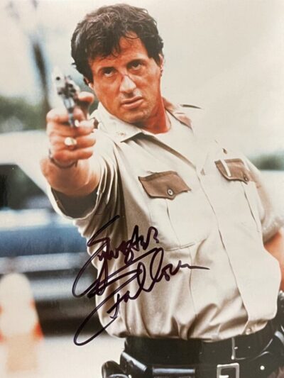 Actor in uniform pointing a gun forward.