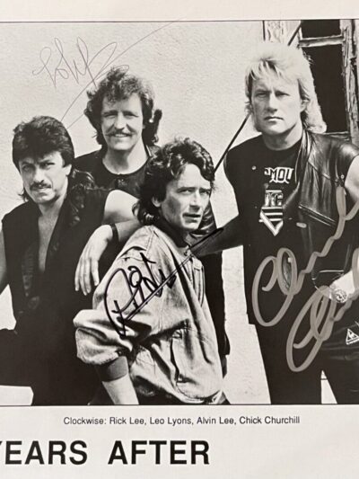 Rock band group photo with autographs.