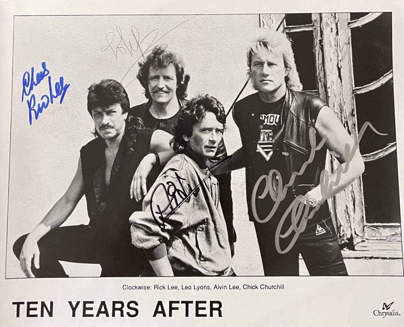 Rock band group photo with autographs.