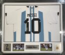 Signed Messi Argentina jersey in display frame.
