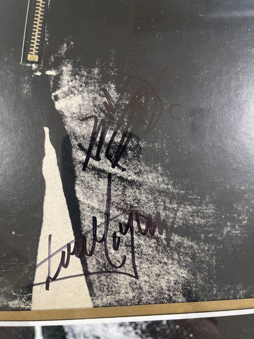 Signed black and white photograph with zipper.