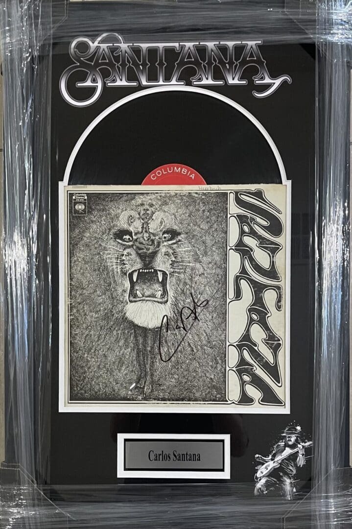 Signed Santana album cover display.