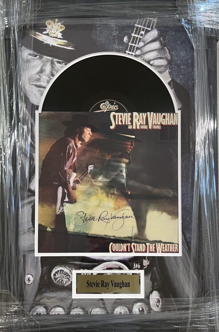 Stevie Ray Vaughan album display with autograph.