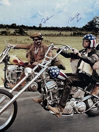 Three men riding motorcycles on an open road.