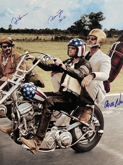 Three men riding motorcycles on a road.