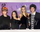 Four people posing at an event.