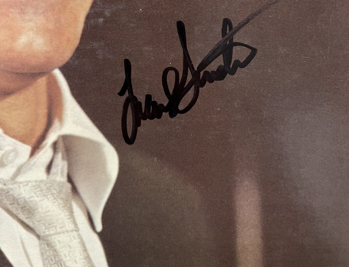 Autograph on suit jacket near collar.