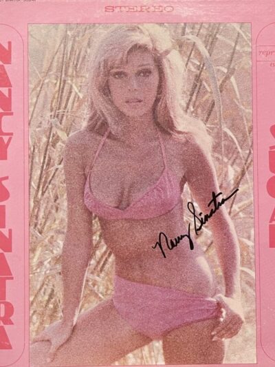 Pink album cover featuring woman in bikini.