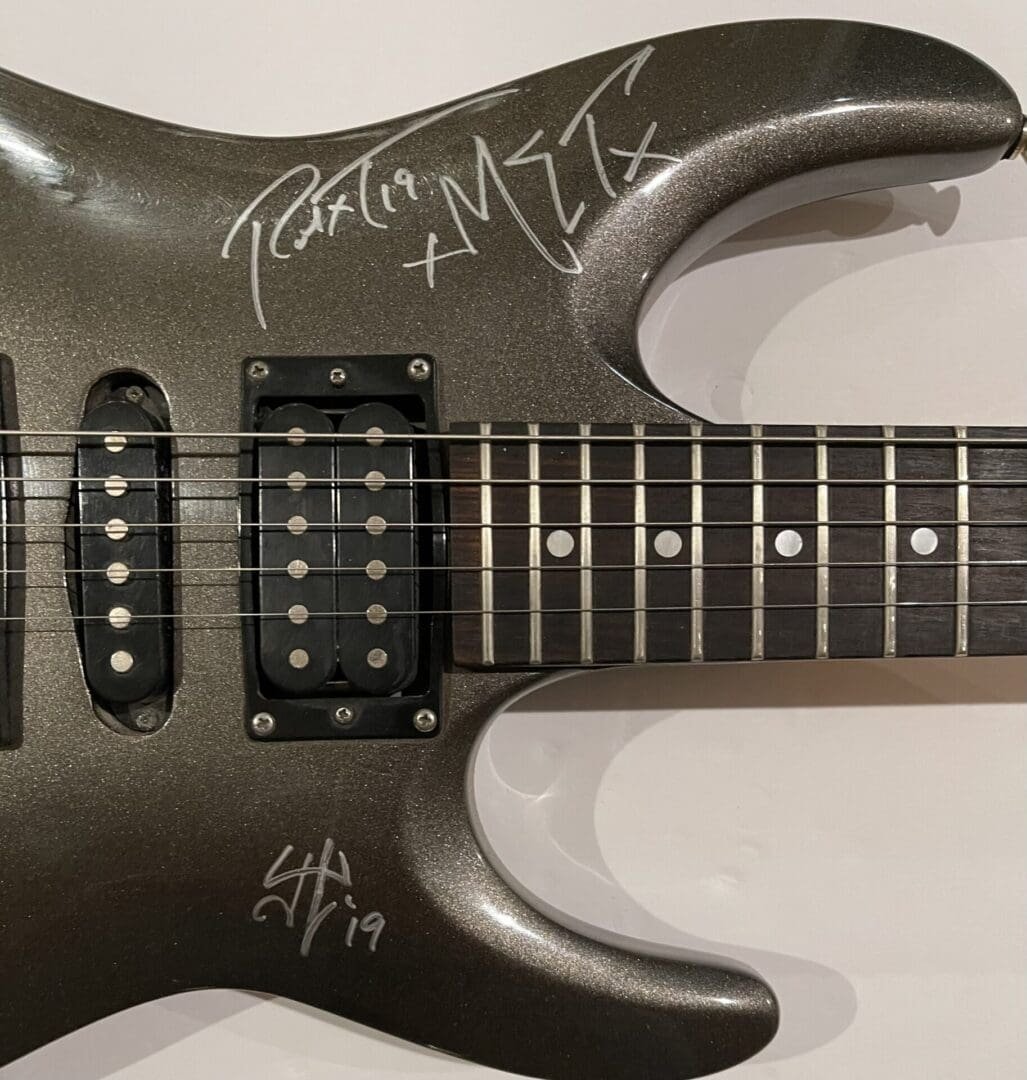 Electric guitar with autographs on the body.
