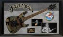 Camouflage guitar with Steve Miller memorabilia display.